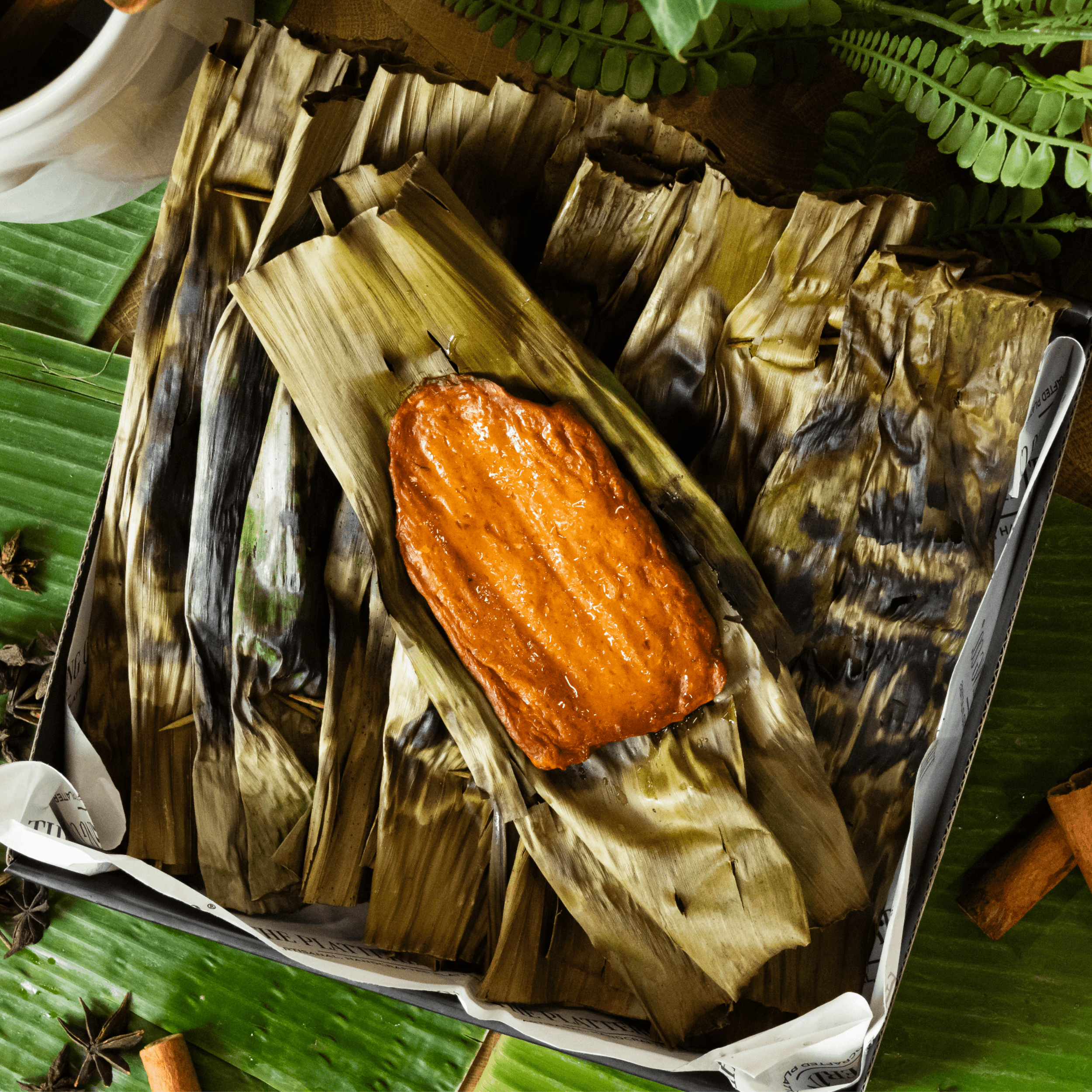 Grilled banana leaf otah arranged in a box, ready for delivery in Singapore